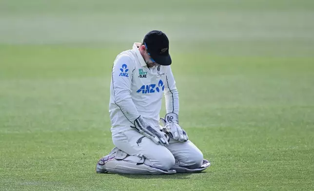 New Zealand's captain Tom Latham kneels on the ground late on Day 5 of their cricket test match against the West Indies in Christchurch, New Zealand, Saturday, Dec. 6, 2025. (Andrew Cornaga/Photosport via AP)