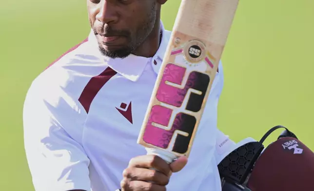 West Indies' Justin Greaves raises his bat after scoring 200 runs against New Zealand on Day 5 of their cricket test match in Christchurch, New Zealand, Saturday, Dec. 6, 2025. (Andrew Cornaga/Photosport via AP)