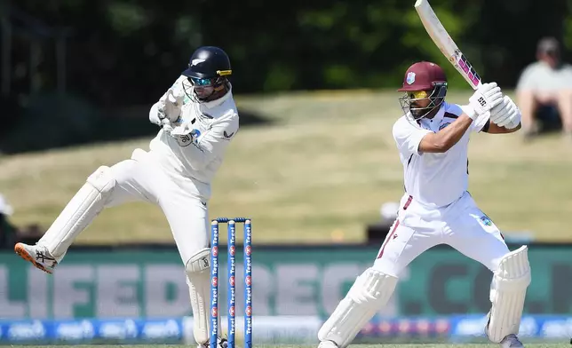 West Indies' Shai Hope, right, bats in front of New Zealand's Tom Blundell on Day 5 of their cricket test match in Christchurch, New Zealand, Saturday, Dec. 6, 2025. (Chris Symes/Photosport via AP)