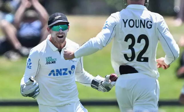 New Zealand's Tom Latham, left, celebrates the wicket of the West Indies' Shai Hope on Day 5 of their cricket test match in Christchurch, New Zealand, Saturday, Dec. 6, 2025. (Andrew Cornaga/Photosport via AP)