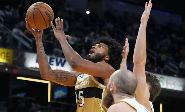 Washington Wizards forward Marvin Bagley III, left, shoots in front of Indiana Pacers center Jay Huff during the first half of an NBA basketball game in Indianapolis, Sunday, Dec. 14, 2025. (AP Photo/AJ Mast)