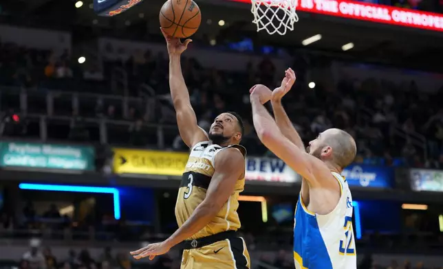 Washington Wizards guard CJ McCollum (3) shoot over Indiana Pacers center Jay Huff during the first half of an NBA basketball game in Indianapolis, Sunday, Dec. 14, 2025. (AP Photo/AJ Mast)