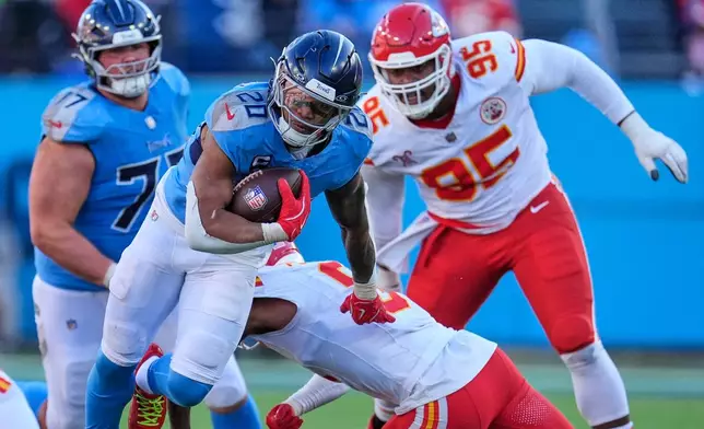 Tennessee Titans running back Tony Pollard (20) gets past Kansas City Chiefs cornerback Kristian Fulton (8) as he runs the ball during the first half of an NFL football game Sunday, Dec. 21, 2025, in Nashville, Tenn. (AP Photo/George Walker IV)