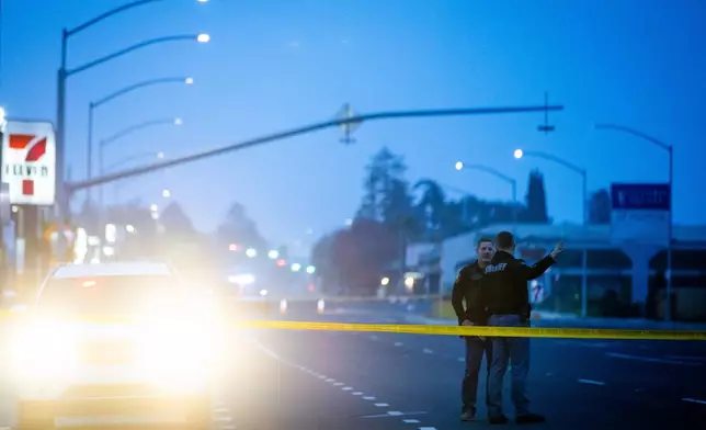 Sheriff deputies stand near the scene of a mass shooting Sunday, Nov. 30, 2025, in Stockton, Calif. (AP Photo/Ethan Swope)