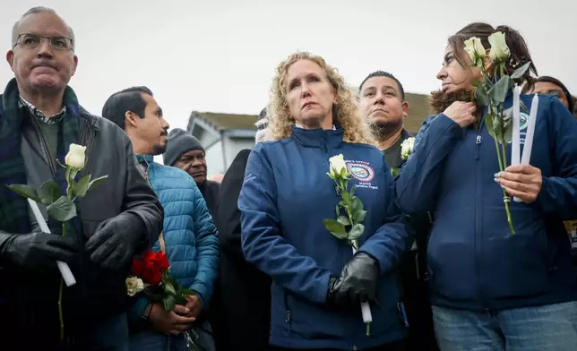 Stockton Mayor Christina Fugazi joins a vigil near the site at Thornton Blvd. and Lucile Ave., where a mass shooting took place Saturday at a banquet hall in Stockton, Calif., Sunday, Nov. 30, 2025. (Brontë Wittpenn/San Francisco Chronicle via AP)