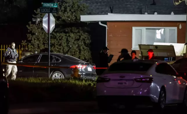 Investigators with the San Joaquin Sheriff's Department stand near the site of a deadly shooting at a home in Stockton, Calif., on Sunday, Nov. 30, 2025. (Carlos Avila Gonzalez/San Francisco Chronicle via AP)