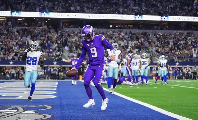 Minnesota Vikings quarterback J.J. McCarthy runs the ball into the end zone for a touchdown during the first half of an NFL football game against the Dallas Cowboys Sunday, Dec. 14, 2025, in Arlington, Texas. (AP Photo/Julio Cortez)