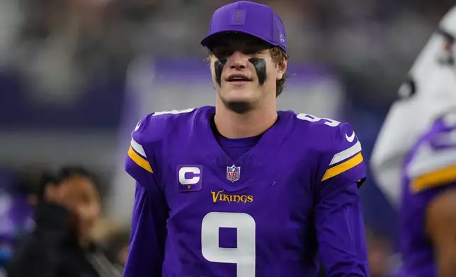 Minnesota Vikings quarterback J.J. McCarthy looks on during the second half of an NFL football game against the Dallas Cowboys Sunday, Dec. 14, 2025, in Arlington, Texas. (AP Photo/Julio Cortez)