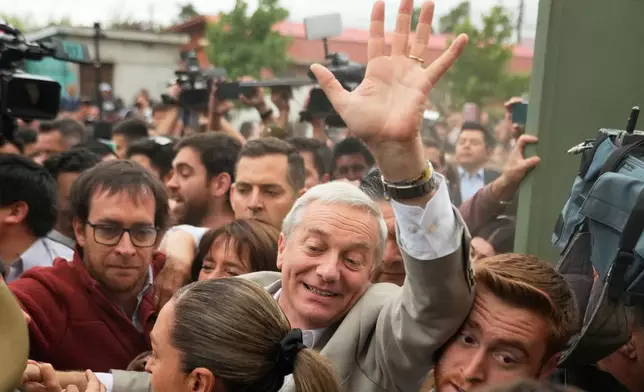 Jose Antonio Kast, presidential candidate for the Republican Party, arrives to vote during the presidential runoff election in Santiago, Chile, Sunday, Dec. 14, 2025. (AP Photo/Matias Delacroix)