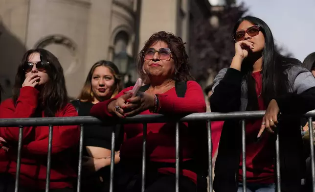 Supporters react to preliminary results at the campaign headquarters of Jeannette Jara, presidential candidate of the ruling Unity for Chile coalition, after polls closed for the presidential runoff in Santiago, Chile, Sunday, Dec. 14, 2025. (AP Photo/Natacha Pisarenko)