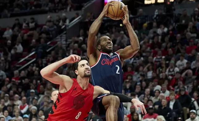 Los Angeles Clippers forward Kawhi Leonard (2) shoots over Portland Trail Blazers forward Deni Avdija (8) during the second half of an NBA basketball game in Portland, Ore., Friday, Dec. 26, 2025. (AP Photo/Craig Mitchelldyer)