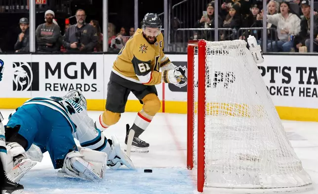 Vegas Golden Knights right wing Mark Stone (61) takes a shot against San Jose Sharks goaltender Alex Nedeljkovic (33) during the second period of an NHL hockey game Tuesday, Dec. 23, 2025, in Las Vegas. (AP Photo/Steve Marcus)