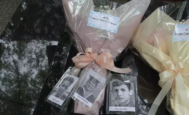 Portraits of Dutch servicemembers held as prisoners of war are placed on a bouquet of flowers laid at a memorial service for those held at the Fukuoka No. 14 Camp in the city of Nagasaki, western Japan, Saturday, Sept. 12, 2025. (AP Photo/Mari Yamaguchi)
