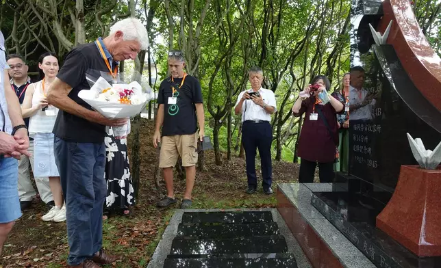 Relatives of former Dutch POWs pay tribute at a monument dedicated to the victims of prison abuse and the atomic bombing of Nagasaki 80 years ago as captives at the Fukuoka No. 14 Camp, at a ceremony, in Nagasaki, western Japan, Friday, Sept. 12, 2025. (AP Photo/Mari Yamaguchi)