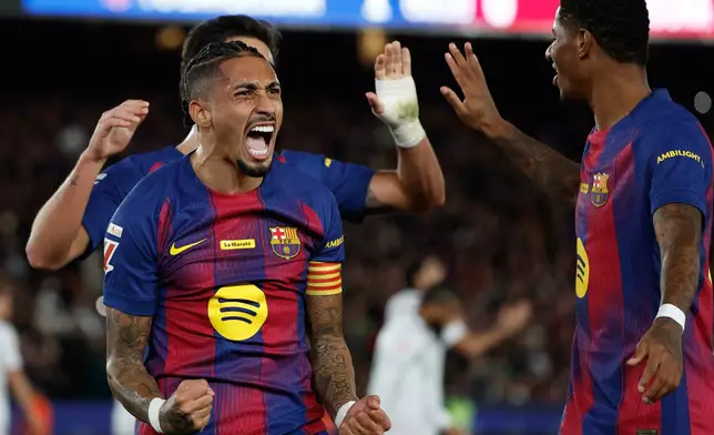 Barcelona's Raphinha celebrates after scoring during a La Liga soccer match between Barcelona and Osasuna in Barcelona, Spain, Saturday, Dec. 13, 2025. AP Photo/Joan Monfort)