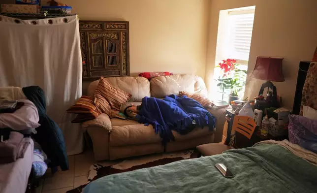 The son of Mayflower Church Deacon, Luo Changcheng, who wasn't feeling well, naps in the room he shares with his parents, in Midland, Texas, Jan. 20, 2025. (AP Photo/Rebecca Blackwell)