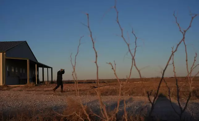 Former Chinese official Li Chuanliang adjusts his cap as he walks inside the Mayflower Church community in Midland, Texas, Jan. 19, 2025. (AP Photo/Rebecca Blackwell)