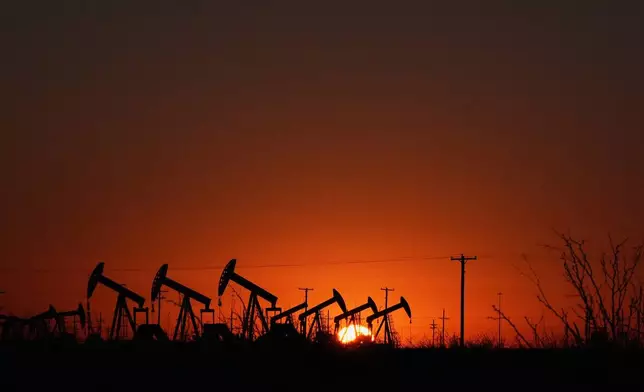 Pumpjacks work to extract oil as the sun rises in Midland, Texas, Jan. 20, 2025. (AP Photo/Rebecca Blackwell)