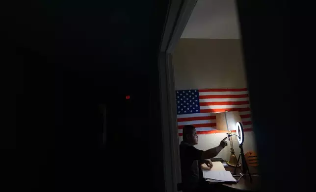 Former Chinese official Li Chuanliang films a YouTube broadcast from the Mayflower Church community in Midland, Texas, Jan. 18, 2025. (AP Photo/Rebecca Blackwell)