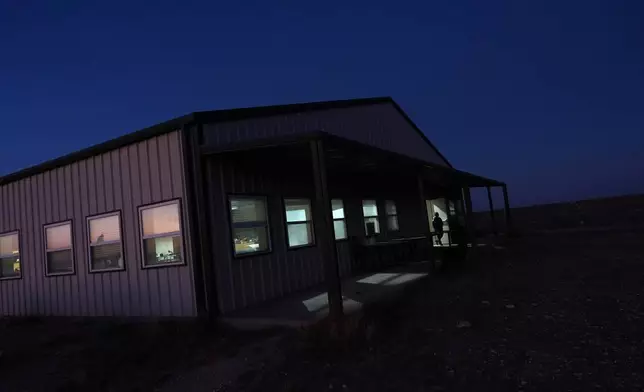 A Mayflower Church member walks out of the community's main hall, used for religious education and recreation, in Midland, Texas, Jan. 18, 2025. (AP Photo/Rebecca Blackwell)