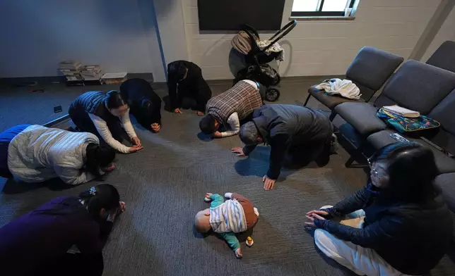 Members of the Mayflower Church, a Christian community which fled religious persecution in China, pray at a church in Midland, Texas, Jan. 19, 2025. (AP Photo/Rebecca Blackwell)