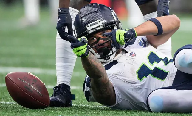 Seattle Seahawks wide receiver Jaxon Smith-Njigba celebrates during the second half of an NFL football game against the Carolina Panthers, Sunday, Dec. 28, 2025, in Charlotte, N.C. (AP Photo/Jacob Kupferman)