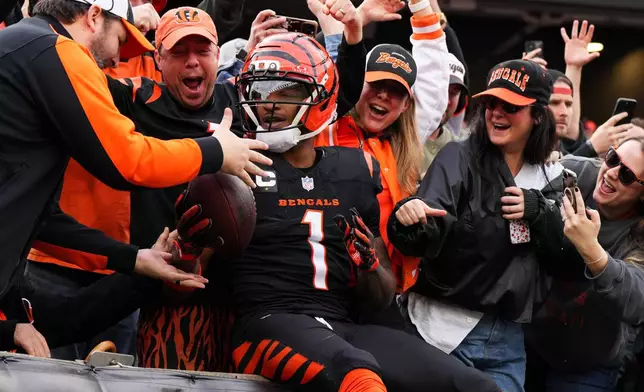 Cincinnati Bengals wide receiver Ja'Marr Chase celebrates with fans after scoring a touchdown during the first half of an NFL football game against the Arizona Cardinals, Sunday, Dec. 28, 2025, in Cincinnati. (AP Photo/Jeff Dean)
