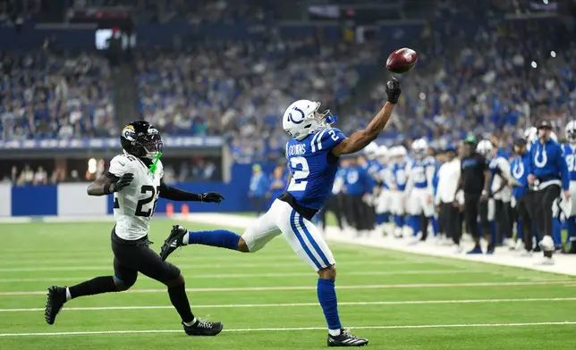 Indianapolis Colts wide receiver Josh Downs, right, is unable to catch a pass as Jacksonville Jaguars cornerback Jarrian Jones (22) defends during the first half of an NFL football game Sunday, Dec. 28, 2025, in Indianapolis. (AP Photo/AJ Mast)