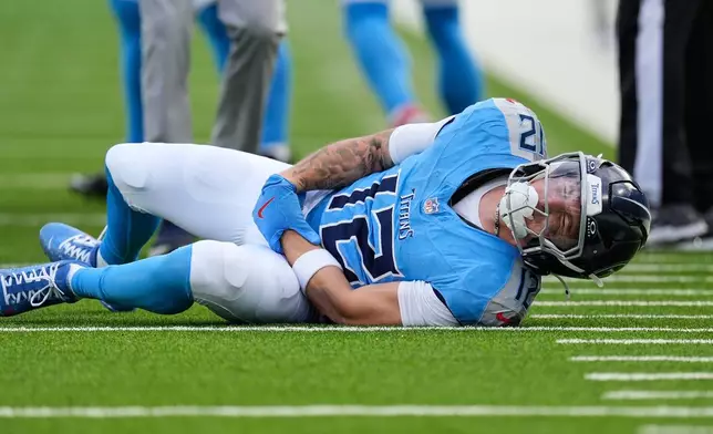 Tennessee Titans wide receiver Mason Kinsey (12) reacts after being injured in the second half of an NFL football game against the New Orleans Saints, Sunday, Dec. 28, 2025, in Nashville, Tenn. (AP Photo/George Walker IV)