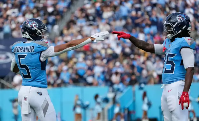 Tennessee Titans wide receiver Elic Ayomanor (5) celebrates his touchdown reception with tight end Chig Okonkwo (85) in the first half of an NFL football game against the New Orleans Saints, Sunday, Dec. 28, 2025, in Nashville, Tenn. (AP Photo/George Walker IV)