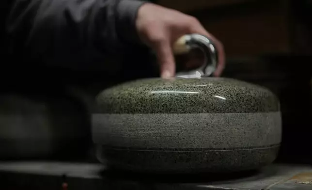A finished curling stone sits in a store room at Kays Curling stone factory in Mauchline, Scotland, Tuesday, Nov. 11, 2025. (AP Photo/Alastair Grant)