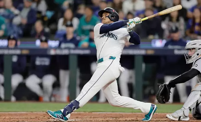 FILE - Seattle Mariners' Jorge Polanco hits a solo home run off Detroit Tigers starting pitcher Tarik Skubal during the sixth inning in Game 2 of baseball's American League Division Series, Sunday, Oct. 5, 2025, in Seattle. (AP Photo/John Froschauer, File)