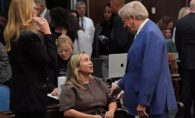FILE - Carli Skaggs, widow of pitcher Tyler Skaggs, center, speaks with attorney Rusty Hardin before opening statements in the trial for the wrongful death lawsuit accusing the Los Angeles Angels baseball team of being responsible for the 2019 drug overdose death Skaggs Tuesday, Oct. 14, 2025, in Santa Ana, Calif. (AP Photo/Jae C. Hong, Pool, file)