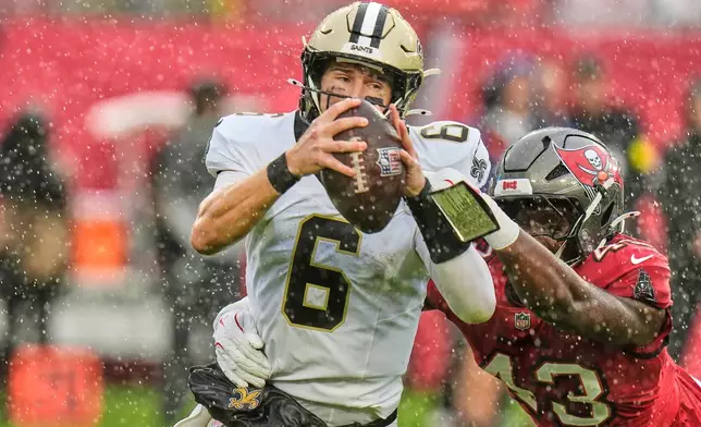 New Orleans Saints quarterback Tyler Shough (6) is sacked by Tampa Bay Buccaneers linebacker Chris Braswell (43) in the first half of an NFL football game, Sunday, Dec. 7, 2025, in Tampa, Fla. (AP Photo/Chris O'Meara)