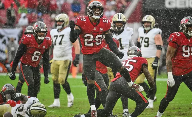 Tampa Bay Buccaneers safety Christian Izien (29) celebrates after stopping the New Orleans Saints on fourth down in the first half of an NFL football game, Sunday, Dec. 7, 2025, in Tampa, Fla. (AP Photo/Jason Behnken)