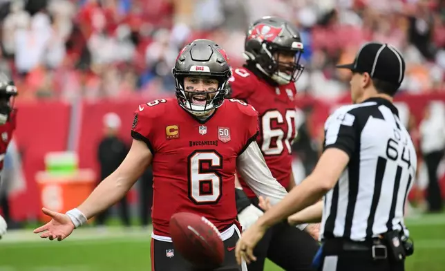 Tampa Bay Buccaneers quarterback Baker Mayfield (6) appeals to down judge Andy Warner (64) for a pass interference call in the second half of an NFL football game against the New Orleans Saints, Sunday, Dec. 7, 2025, in Tampa, Fla. (AP Photo/Jason Behnken)