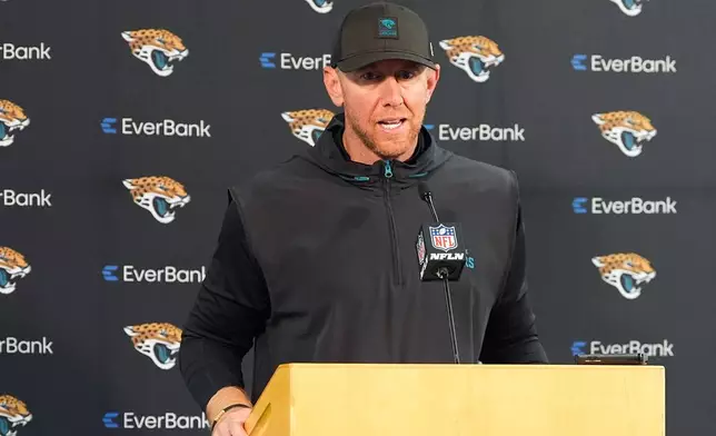 Jacksonville Jaguars head coach Liam Coen speaks during a news conference after an NFL football game against the Denver Broncos in Denver, Sunday, Dec. 21, 2025. (AP Photo/David Zalubowski)