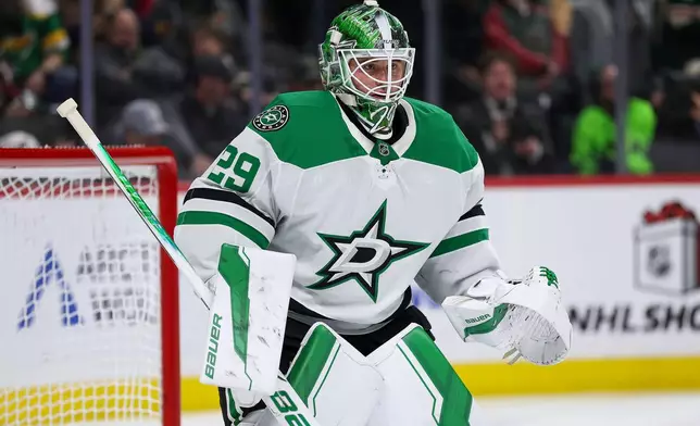 Dallas Stars goaltender Jake Oettinger (29) defends his net against the Minnesota Wild during the second period of an NHL hockey game Thursday, Dec. 11, 2025, in St. Paul, Minn. (AP Photo/Matt Krohn)