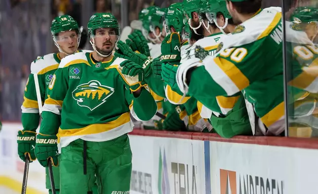 Minnesota Wild left wing Marcus Johansson (90) celebrates his goal with teammates during the third period of an NHL hockey game against the Dallas Stars Thursday, Dec. 11, 2025, in St. Paul, Minn. (AP Photo/Matt Krohn)