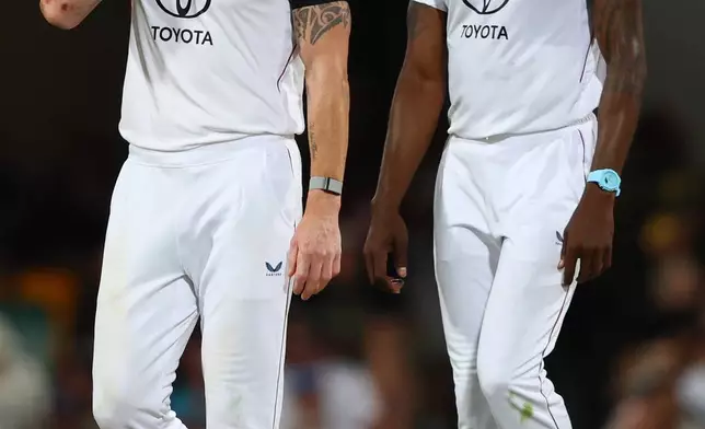 England's captain Ben Stokes, left, talks to England's Jofra Archer during the second Ashes cricket test match between Australia and England in Brisbane, Sunday, Dec. 7, 2025.. (AP Photo/Tertius Pickard)