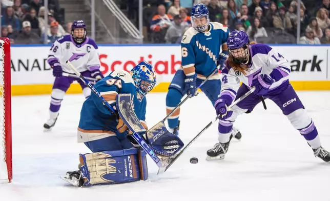 Minnesota Frost Dominique Petrie (14) shoots on Vancouver Goldeneyes goalie Emerance Maschmeyer (38) as Sophie Jaques (16) and Kendall Coyne-Schofield (26) look on during the first period of an PWHL game in Edmonton, Saturday, Dec. 27, 2025. (Amber Bracken/The Canadian Press via AP)