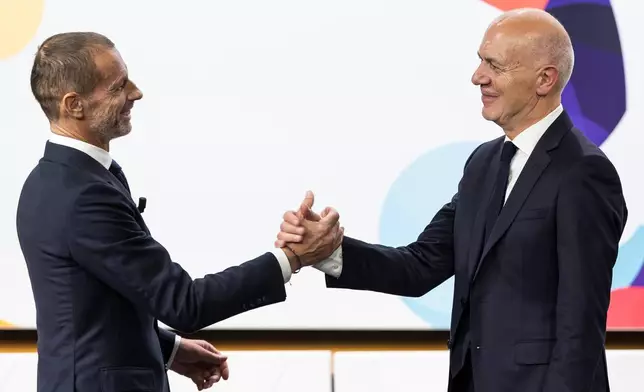 UEFA President Aleksander Ceferin, left, and German Football Association (DFB) president Bernd Neuendorf, right, shake hands during the the announcement ceremony for the host country of the UEFA Women's EURO 2029, in Nyon, Switzerland, Wednesday, Dec. 3, 2025. (Cyril Zingaro/Keystone via AP)