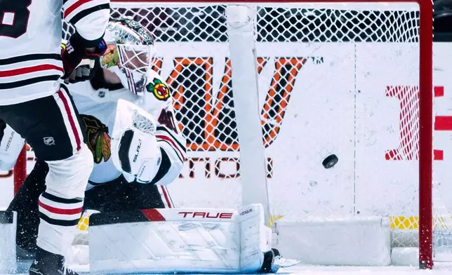 Chicago Blackhawks goaltender Arvid Soderblom (40) watches as the Anaheim Ducks score during the second period of an NHL hockey game Sunday, Dec. 7, 2025, in Anaheim, Calif. (AP Photo/Ethan Swope)