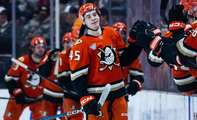 Anaheim Ducks right wing Beckett Sennecke (45) reacts after scoring against the Chicago Blackhawks during the second period of an NHL hockey game Sunday, Dec. 7, 2025, in Anaheim, Calif. (AP Photo/Ethan Swope)