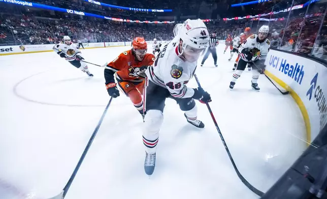 Chicago Blackhawks defenseman Louis Crevier (46) defends the puck against the Anaheim Ducks during the first period of an NHL hockey game Sunday, Dec. 7, 2025, in Anaheim, Calif. (AP Photo/Ethan Swope)