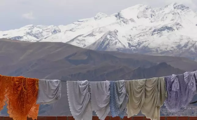 Skirts hang drying in El Alto, Bolivia, Monday, Oct. 13, 2025. (AP Photo/Juan Karita)
