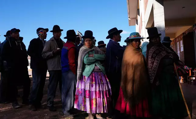 FILE - Voters stand in line at a polling station during general elections in Jesus de Machaca, Bolivia, Aug. 17, 2025. (AP Photo/Juan Karita, File)