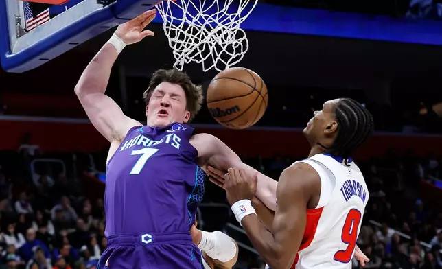 Charlotte Hornets guard Kon Knueppel (7) dunks against Detroit Pistons guard Ausar Thompson (9) during the first half of an NBA basketball game Saturday, Dec. 20, 2025, in Detroit. (AP Photo/Duane Burleson)