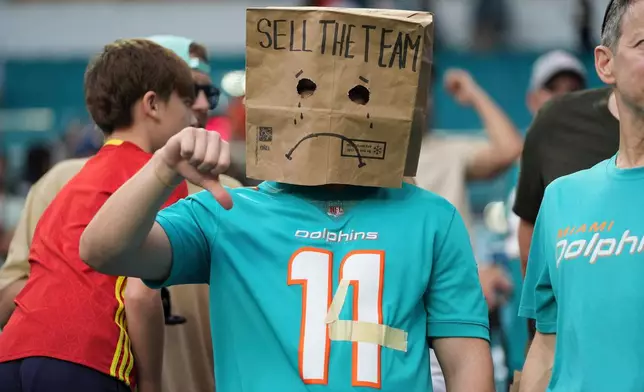 A fan shows his frustration with the Miami Dolphins following an NFL football game against the Cincinnati Bengals, Sunday, Dec. 21, 2025, in Miami Gardens, Fla. (AP Photo/Lynne Sladky)