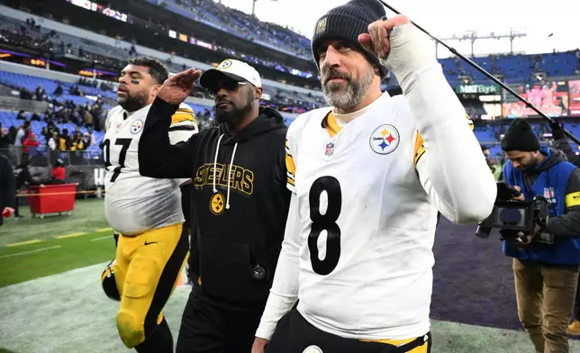 Pittsburgh Steelers head coach Mike Tomlin and quarterback Aaron Rodgers (8) leave the field after an NFL football game against the Baltimore Ravens, Sunday, Dec. 7, 2025, in Baltimore. (AP Photo/Nick Wass)